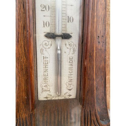 1219 - A VINTAGE WOODEN CASED ANEROID BAROMETER