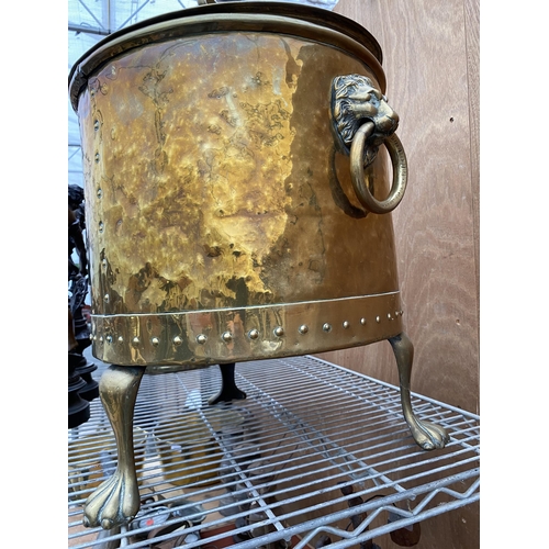 1227 - A VINTAGE BRASS COAL BUCKET WITH LION HEAD HANDLES AND LION PAW FEET