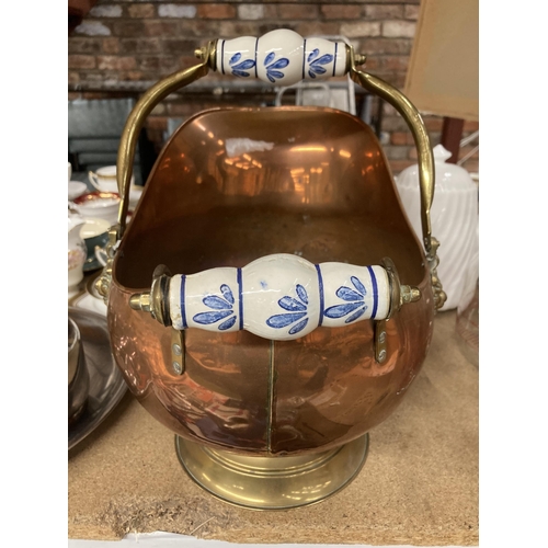 284 - A COPPER FOOTED COAL SCUTTLE WITH BRASS HANDLE AND CERAMIC DETAIL