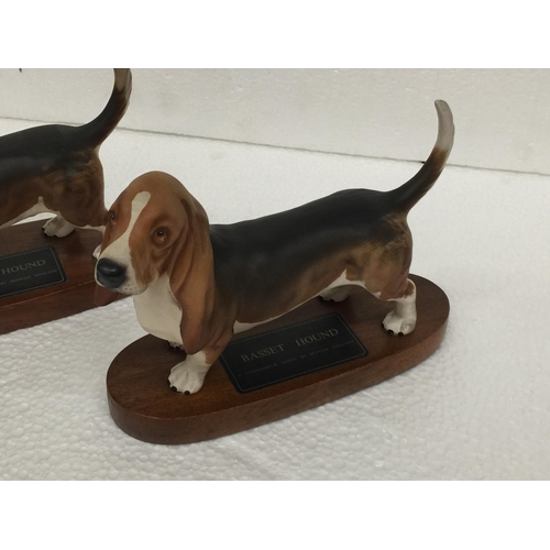 909 - TWO BESWICK BASSETT HOUNDS ON PLINTHS