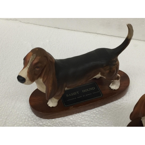 909 - TWO BESWICK BASSETT HOUNDS ON PLINTHS