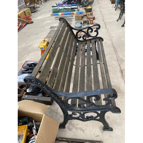 1351 - A WOODEN SLATTED GARDEN BENCH WITH CAST IRON BENCH ENDS