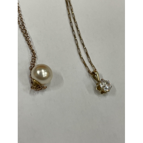 578 - THREE NECKLACES WITH PENDANTS TO INCLUDE, TWO 9 CARAT GOLD ONE WITH A PEARL AND ONE WITH A CLEAR STO... 