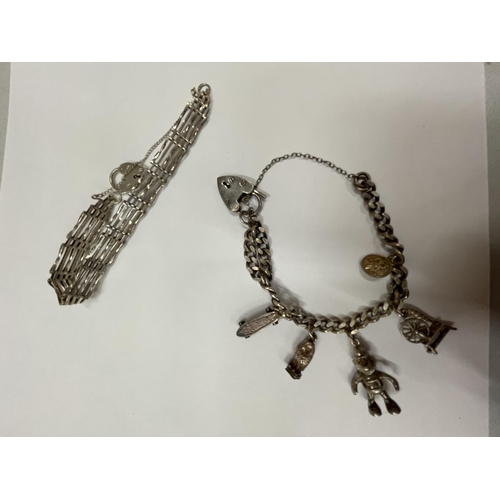 581 - TWO SILVER BRACELETS TO INCLUDE A CHARM BRACELET WITH FIVE CHARMS AND A FIVE BAR GATE BRACELET