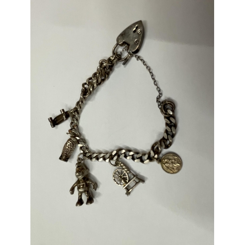 581 - TWO SILVER BRACELETS TO INCLUDE A CHARM BRACELET WITH FIVE CHARMS AND A FIVE BAR GATE BRACELET