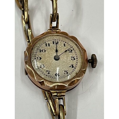 587 - A 9 CARAT GOLD WRISTWATCH WITH 9 CARAT GOLD EXPANDING STRAP