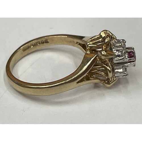 596 - A 9 CARAT GOLD RING WITH CENTRE RUBY SURROUNDED BY CUBIC ZIRCONIAS SIZE K