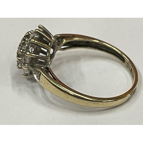 597 - A 9 CARAT GOLD DIAMOND CLUSTER RING SIZE N