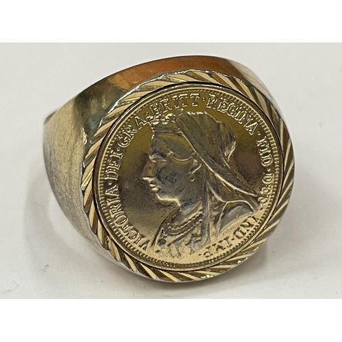 749 - A YELLOW METAL RING WITH A GOLD COLOURED COIN