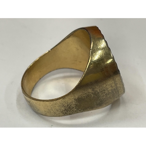 749 - A YELLOW METAL RING WITH A GOLD COLOURED COIN