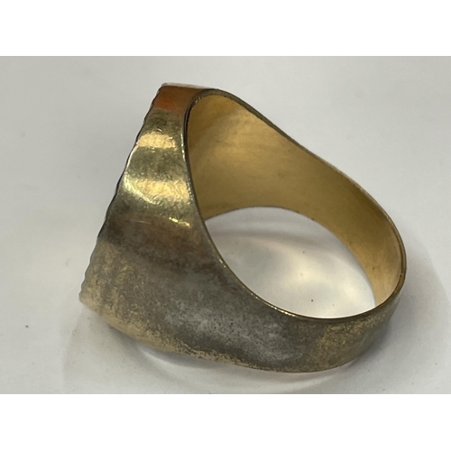 749 - A YELLOW METAL RING WITH A GOLD COLOURED COIN