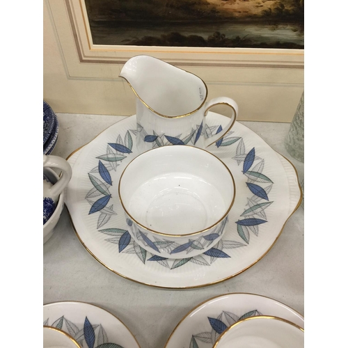 1053 - A ROYAL STANDARD 'TREND' TEASET TO INCLUDE A CAKE PLATE, CUPS, SAUCERS, CREAM JUG AND A SUGARBOWL