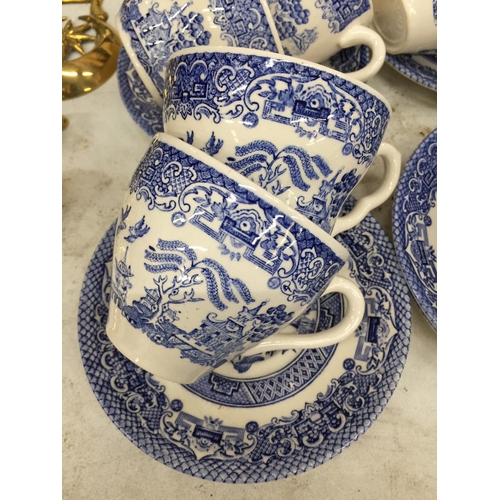 1054 - A LARGE QUANTITY OF BLUE AND WHITE CUPS AND SAUCERS PLUS A CREAM JUG AND SUGAR BOWL