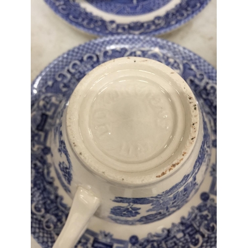 1054 - A LARGE QUANTITY OF BLUE AND WHITE CUPS AND SAUCERS PLUS A CREAM JUG AND SUGAR BOWL