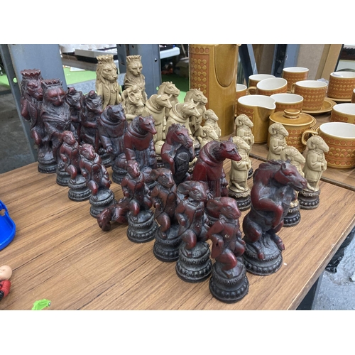 952 - THIRTY CHESS PIECES IN RED AND WHITE WITH ANIMAL CHARACTERS - SOME A/F