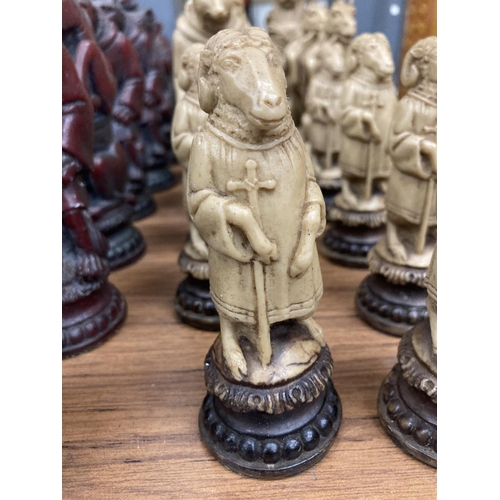 952 - THIRTY CHESS PIECES IN RED AND WHITE WITH ANIMAL CHARACTERS - SOME A/F