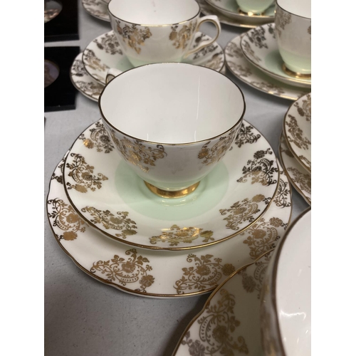 970 - A ROYAL TRON TEASET IN PALE GREEN AND GILT TO INCLUDE A CAKE PLATE, SUGAR BOWL, CREAM JUG, CUPS, SAU... 