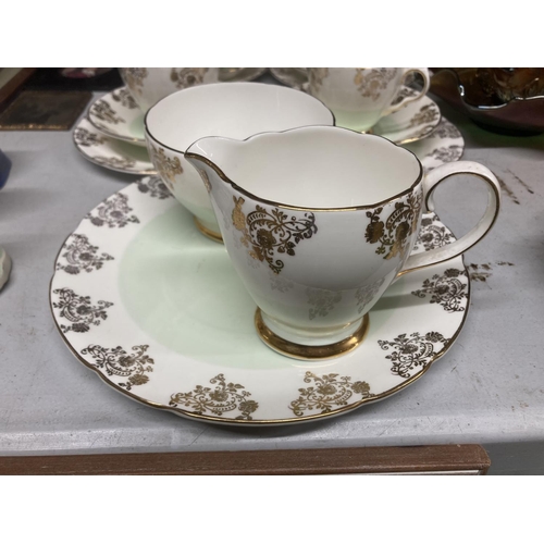 970 - A ROYAL TRON TEASET IN PALE GREEN AND GILT TO INCLUDE A CAKE PLATE, SUGAR BOWL, CREAM JUG, CUPS, SAU... 