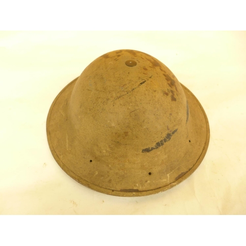 479 - A WORLD WAR II DESERT COLOURED PAINTED BRODIE HELMET AND LINEN