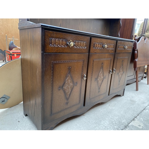 2488 - AN OAK DRESSER WITH THREE LOWER DOORS AND DRAWERS AND PLATE RACK WITH TWO GLAZED UPPER DOORS