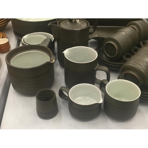 134 - A LARGE QUANTITY OF DENBY STONEWARE TO INCLUDE SERVING DISHES, VARIOUS SIZES OF PLATES, COFFEE AND T... 