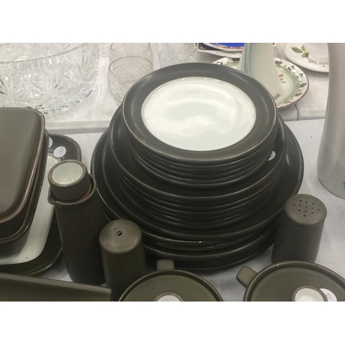 134 - A LARGE QUANTITY OF DENBY STONEWARE TO INCLUDE SERVING DISHES, VARIOUS SIZES OF PLATES, COFFEE AND T... 