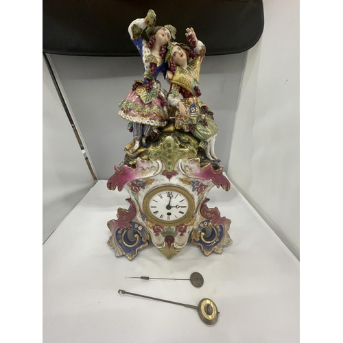 28 - A DECORATIVE FRENCH PORCELAIN MANTLE CLOCK WITH A COURTING COUPLE AND GRAPES DECORATION