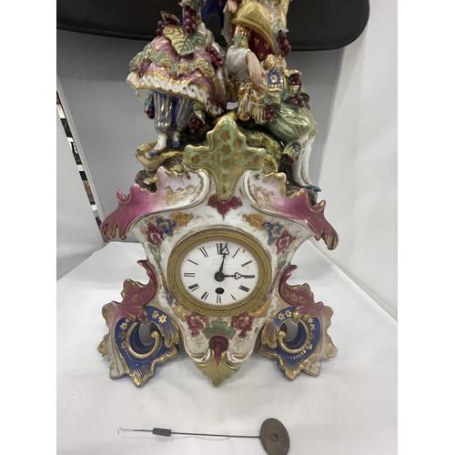 28 - A DECORATIVE FRENCH PORCELAIN MANTLE CLOCK WITH A COURTING COUPLE AND GRAPES DECORATION