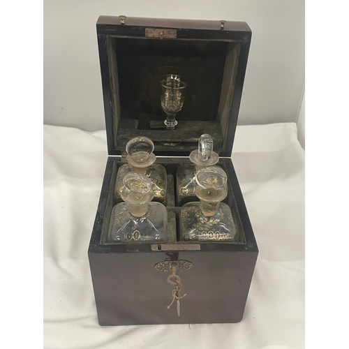 37 - A VINTAGE MAHOGANY LIQUER CASE WITH FOUR DECANTERS AND ONE GLASS COMPLETE WITH LABELLED KEY