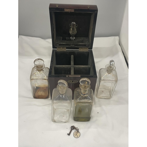 37 - A VINTAGE MAHOGANY LIQUER CASE WITH FOUR DECANTERS AND ONE GLASS COMPLETE WITH LABELLED KEY