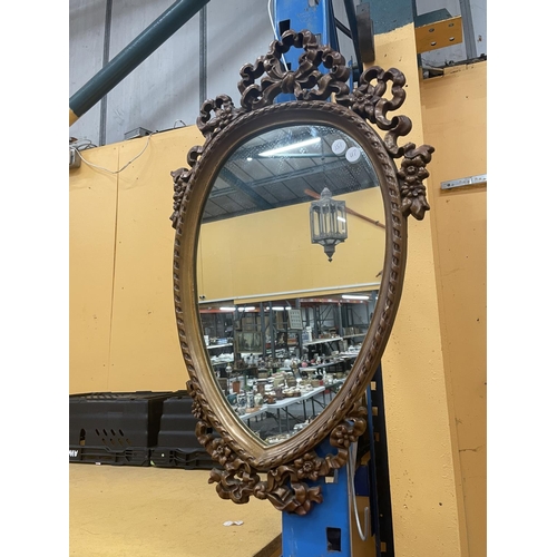 46 - AN ORNATE WOODEN FRAMED MIRROR