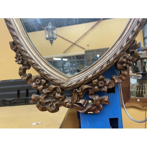 46 - AN ORNATE WOODEN FRAMED MIRROR