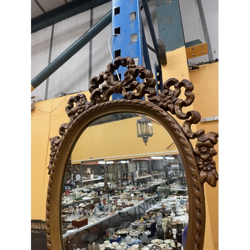 46 - AN ORNATE WOODEN FRAMED MIRROR