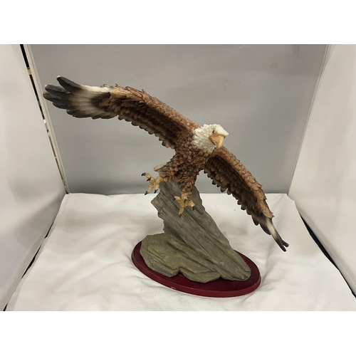 56A - A RESIN FIGURE OF A BALD EAGLE IN HUNTING FLIGHT