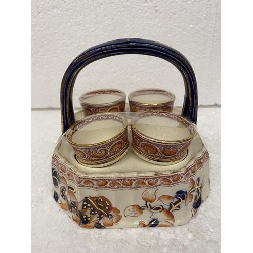 119 - A VINTAGE IMARI STYLE STAND WITH FOUR EGG CUPS