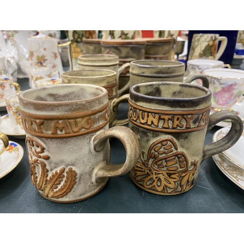 74 - A QUANTITY OF STUDIO POTTERY STORAGE JARS AND MUGS