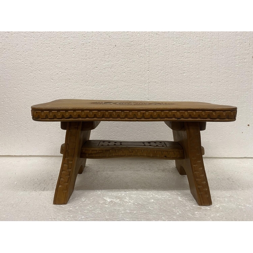 87 - A WOODEN STOOL WITH ENGRAVED DECORATION HEIGHT 17CM, WIDTH 35CM