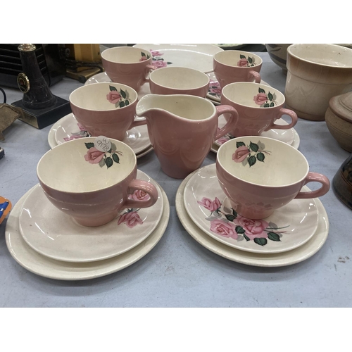 185 - A WADE TEASET IN PINK WITH A ROSE PATTERN TO INCLUDE A CAKE PLATE, CREAM JUG, SUGAR BOWL, CUPS, SAUC... 