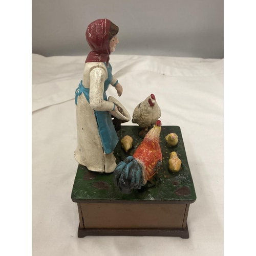 198 - A VINTAGE STYLE CAST MONEY BANK OF A LADY FEEDING CHICKENS, TURN THE HANDLE AND 'OLD McDONALD HAD A ... 