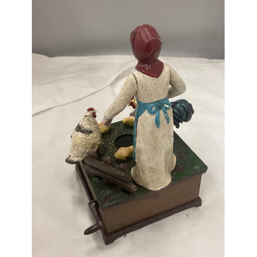 198 - A VINTAGE STYLE CAST MONEY BANK OF A LADY FEEDING CHICKENS, TURN THE HANDLE AND 'OLD McDONALD HAD A ... 