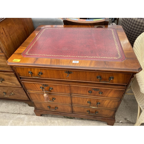 2392 - A MAHOGANY ANTIQUE STYLE OFFICE DESK IN THE FORM OF A CHEST OF DRAWERS WITH INSET LEATHER TOP AND PU... 