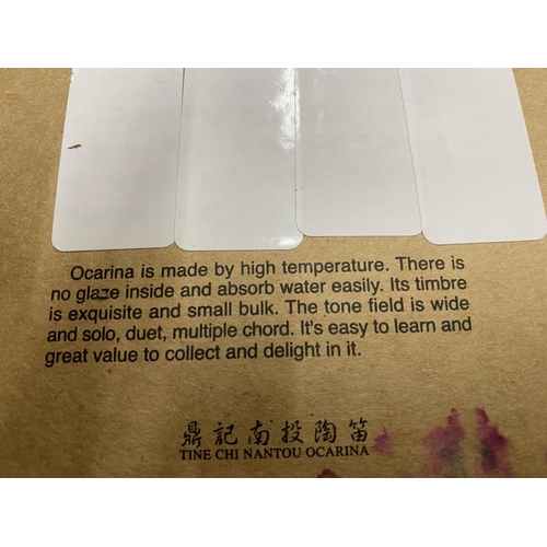 144 - A BOXED MOUTH FLUTE