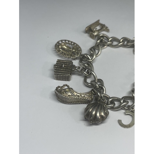 529 - A SILVER CHARM BRACELET WITH EIGHT CHARMS