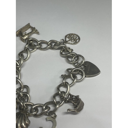 529 - A SILVER CHARM BRACELET WITH EIGHT CHARMS