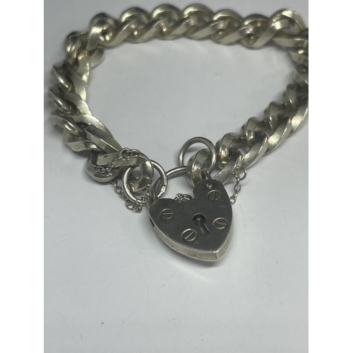 536 - A HEAVY MARKED SILVER BRACELET WITH A HEART LOCK