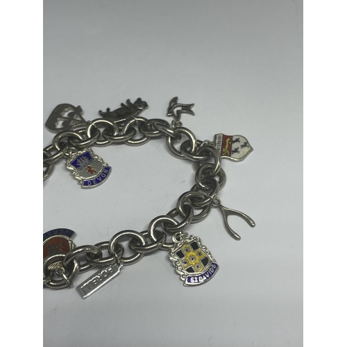 540 - A MARKED SILVER CHARM BRACELET WITH TEN CHARMS