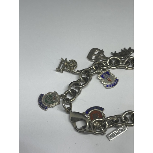 540 - A MARKED SILVER CHARM BRACELET WITH TEN CHARMS