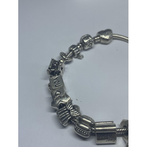 635 - A PANDORA BRACELET WITH SIXTEEN CHARMS IN A PRESENTATION BOX