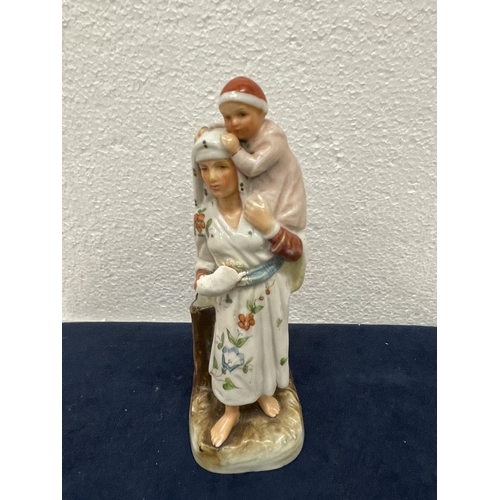 411 - A VINTAGE CONTINENTAL CERAMIC OF A MOTHER AND CHILD WITH MATCH HOLDER AND STRIKER