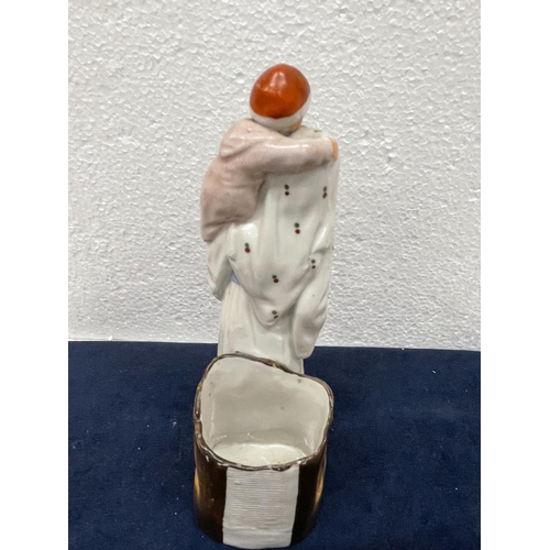 411 - A VINTAGE CONTINENTAL CERAMIC OF A MOTHER AND CHILD WITH MATCH HOLDER AND STRIKER